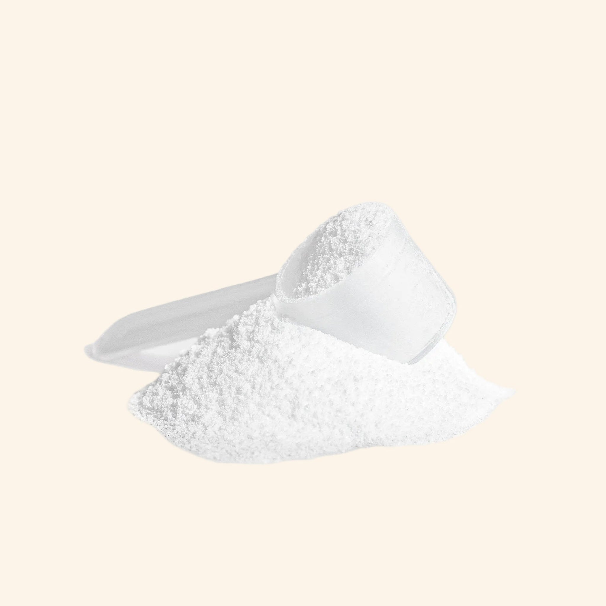 White powder in a measuring spoon on a white background
